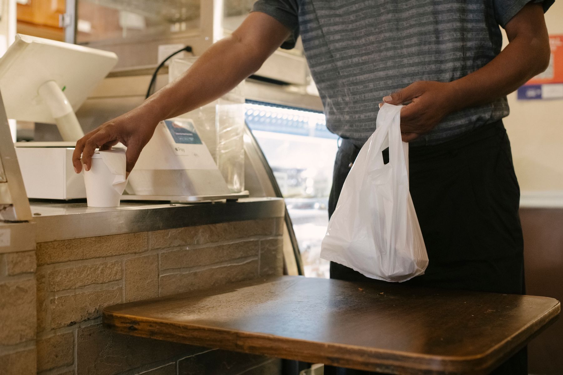 Customer collecting a prepared restaurant order.